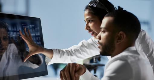 Scientists Working on Computer In Modern Laboratory
